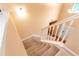A staircase with carpet steps and white railing at 3265 Watson Gate Rd, Loganville, GA 30052
