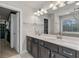 Bathroom with double vanity with white countertop and dark cabinets with silver hardware at 3560 Summerpoint Xing, Cumming, GA 30028