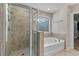 Bright bathroom featuring glass enclosed shower and soaking tub, perfect for relaxation at 3560 Summerpoint Xing, Cumming, GA 30028