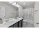 Well-lit bathroom featuring a vanity with double sinks and modern black and white patterned floors at 3560 Summerpoint Xing, Cumming, GA 30028