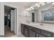 Bright bathroom featuring double sinks, granite countertops, and a large mirror at 3560 Summerpoint Xing, Cumming, GA 30028