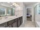 Bright bathroom featuring double sinks, granite countertops, and a walk-in shower at 3560 Summerpoint Xing, Cumming, GA 30028