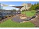 Community area featuring a cozy firepit, shade cover, outdoor seating, and meticulous landscaping at 3560 Summerpoint Xing, Cumming, GA 30028