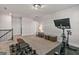 Home gym featuring an exercise bike, dumbbells, weight bench, and TV at 3560 Summerpoint Xing, Cumming, GA 30028
