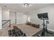 Bright home gym with gym equipment, Peloton, and staircase to another room at 3560 Summerpoint Xing, Cumming, GA 30028