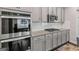 Kitchen featuring stainless steel appliances and white cabinetry at 3560 Summerpoint Xing, Cumming, GA 30028