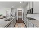 Bright kitchen with gray cabinets, granite countertops, stainless appliances and access to pantry at 3560 Summerpoint Xing, Cumming, GA 30028