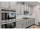 Modern kitchen design with stainless steel appliances, gas range, double oven, and gray cabinets at 3560 Summerpoint Xing, Cumming, GA 30028
