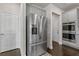 Kitchen with stainless steel refrigerator, double ovens, gray cabinets, and hardwood floors at 3560 Summerpoint Xing, Cumming, GA 30028