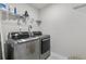 Functional laundry room equipped with modern, front-loading washer and dryer at 3560 Summerpoint Xing, Cumming, GA 30028