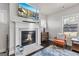 Cozy living room with fireplace, marble hearth, comfortable seating, and television mounted above the mantel at 3560 Summerpoint Xing, Cumming, GA 30028