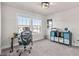 Office with a large window, a desk with a rolling chair and storage shelves for optimal organization at 3560 Summerpoint Xing, Cumming, GA 30028