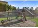 Community playground with swing set and slide built into a grassy hillside at 3560 Summerpoint Xing, Cumming, GA 30028