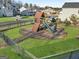 Community playground featuring a slide, swing, and climbing structure, set in a fenced grassy area at 3560 Summerpoint Xing, Cumming, GA 30028