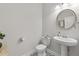 Clean powder room featuring pedestal sink, toilet, and decorative tile flooring at 3560 Summerpoint Xing, Cumming, GA 30028