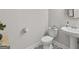 Powder room featuring patterned tile floor, sink, and a round mirror at 3560 Summerpoint Xing, Cumming, GA 30028