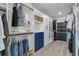 Organized walk-in closet featuring shelving, hanging rods, and blue drawers for optimal storage at 3560 Summerpoint Xing, Cumming, GA 30028