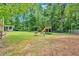 Beautiful backyard with a playground set, well-kept lawn, and a view of the home's screened porch at 3663 Homewood Trl, Powder Springs, GA 30127