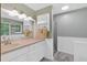 Bathroom with a white vanity, large mirror, tub and shower, with tile and natural light at 3663 Homewood Trl, Powder Springs, GA 30127