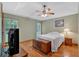 Cozy bedroom with hardwood floors, neutral paint, ceiling fan, and ample natural light at 3663 Homewood Trl, Powder Springs, GA 30127