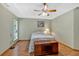 Bedroom featuring wood floors, ceiling fan and a large window for natural light at 3663 Homewood Trl, Powder Springs, GA 30127