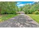 Long driveway leads to a charming single-Gathering home with attached two car garage at 3663 Homewood Trl, Powder Springs, GA 30127