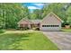 Charming single-story home featuring a well-maintained lawn and a two-car garage at 3663 Homewood Trl, Powder Springs, GA 30127