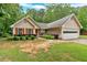 Charming single-story home featuring a well-maintained lawn and a two-car garage at 3663 Homewood Trl, Powder Springs, GA 30127
