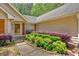 Beautifully landscaped front yard with lush greenery leading to the front door at 3663 Homewood Trl, Powder Springs, GA 30127