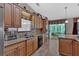 Kitchen featuring wooden cabinets, tile backsplash, stainless steel appliances, and access to sunroom at 3663 Homewood Trl, Powder Springs, GA 30127