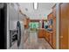 Well-lit kitchen with wooden cabinetry, tile floors, granite counters, and stainless steel refrigerator at 3663 Homewood Trl, Powder Springs, GA 30127