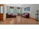 Cozy living room featuring leather sofas, natural light, and hardwood floors at 3663 Homewood Trl, Powder Springs, GA 30127