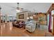 Open-concept living room connected to the kitchen, featuring hardwood floors and a ceiling fan at 3663 Homewood Trl, Powder Springs, GA 30127