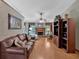 Spacious living room featuring a brick fireplace, ceiling fan, and hardwood flooring at 3663 Homewood Trl, Powder Springs, GA 30127