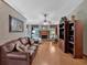 Inviting living room featuring a brick fireplace, hardwood floors, and comfortable seating at 3663 Homewood Trl, Powder Springs, GA 30127