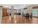 Spacious living room with hardwood floors, a dining area, and large windows offering natural light at 3663 Homewood Trl, Powder Springs, GA 30127