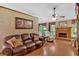 Relaxing living room with a brick fireplace, a ceiling fan, and a beautiful painting at 3663 Homewood Trl, Powder Springs, GA 30127