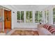 Bright sunroom with multiple windows, tile flooring, and comfortable seating area at 3663 Homewood Trl, Powder Springs, GA 30127