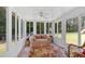 Bright sunroom with multiple windows offering backyard views, and wicker furniture at 3663 Homewood Trl, Powder Springs, GA 30127