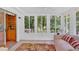 Bright sunroom with multiple windows offering backyard views and a cabinet at 3663 Homewood Trl, Powder Springs, GA 30127