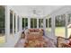 Bright sunroom with multiple windows, tile flooring, and comfortable seating area at 3663 Homewood Trl, Powder Springs, GA 30127