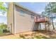 Backyard features vinyl siding, a small deck, and mature landscaping at 4417 Roche St, Atlanta, GA 30349