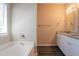 Bright bathroom featuring a tub, granite counters and white cabinets at 4417 Roche St, Atlanta, GA 30349