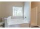 Bathroom featuring a soaking tub, shower, and neutral fixtures at 4417 Roche St, Atlanta, GA 30349