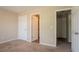 Bedroom features plush carpet, neutral colors, and three entry doors at 4417 Roche St, Atlanta, GA 30349