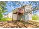 A charming home exterior features a spacious deck and backyard with mature trees, perfect for outdoor living at 4417 Roche St, Atlanta, GA 30349