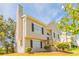 Pleasant view of the two-story house with a staircase leading to the arched front door at 4417 Roche St, Atlanta, GA 30349