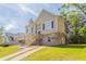 Inviting two-story house featuring a front staircase and manicured lawn on a sunny day at 4417 Roche St, Atlanta, GA 30349