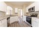 Bright kitchen featuring granite counters, stainless appliances, and white cabinetry at 4417 Roche St, Atlanta, GA 30349