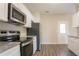 Modern kitchen with stainless steel appliances, granite countertops, and sleek cabinets at 4417 Roche St, Atlanta, GA 30349